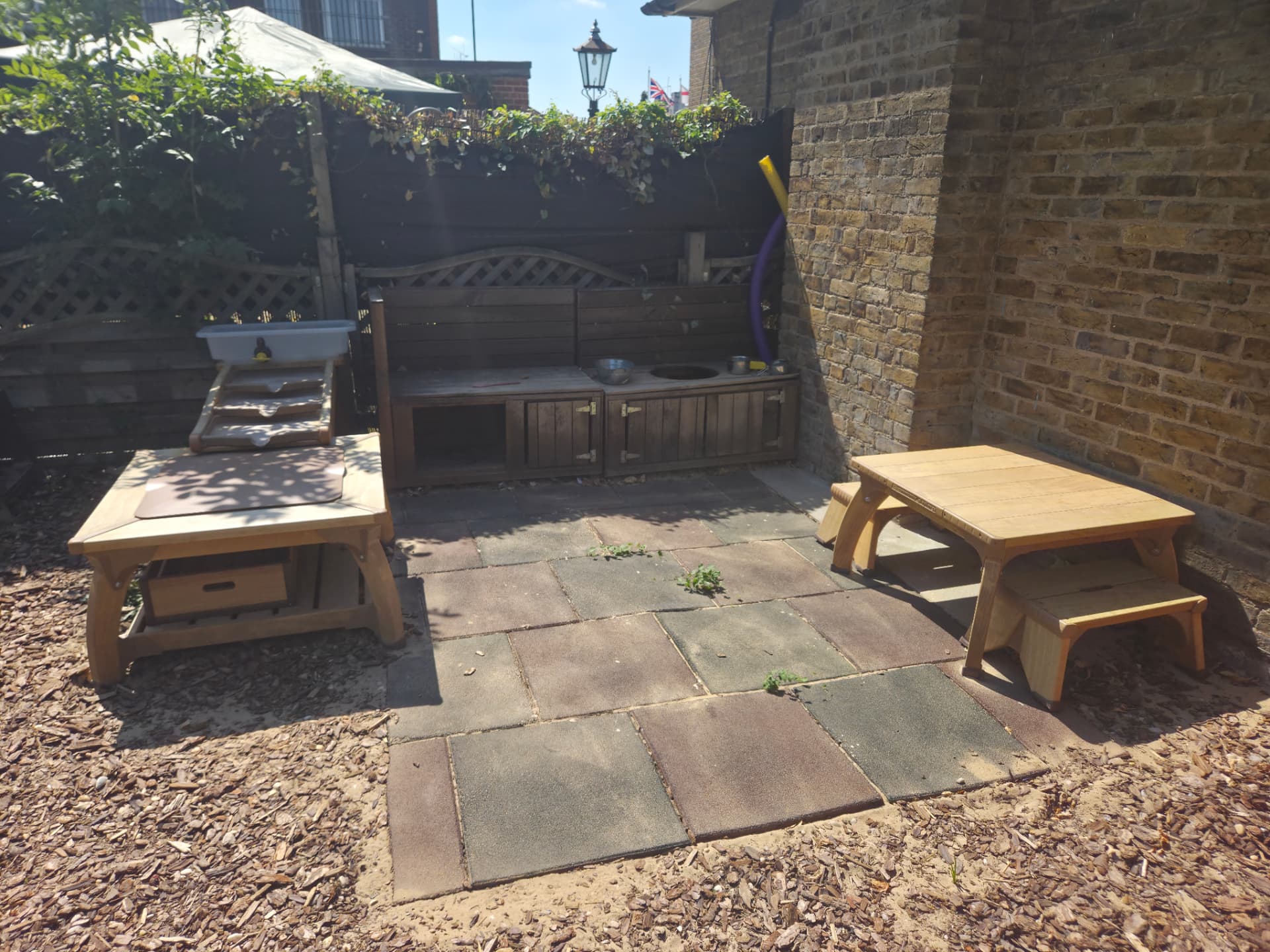 Our outdoor mud kitchen with wooden workbench and play resources